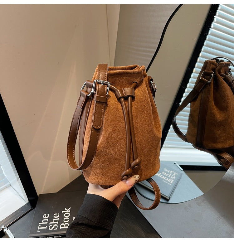 The Sienna Faux-Suede Drawstring Bucket Bag in Cognac Brown